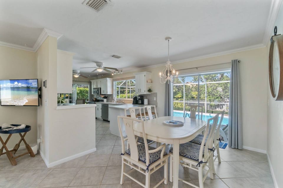 The dining area is conveniently located off the kitchen with views of the screened-in lanai and pool.