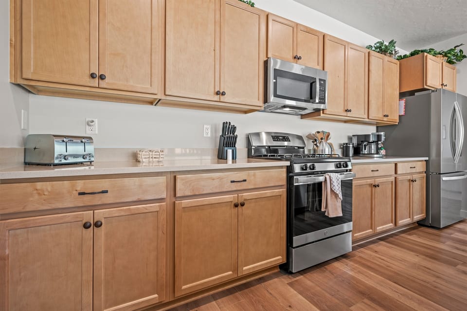 Beautifully equipped kitchen with warm wood cabinetry and modern appliances.