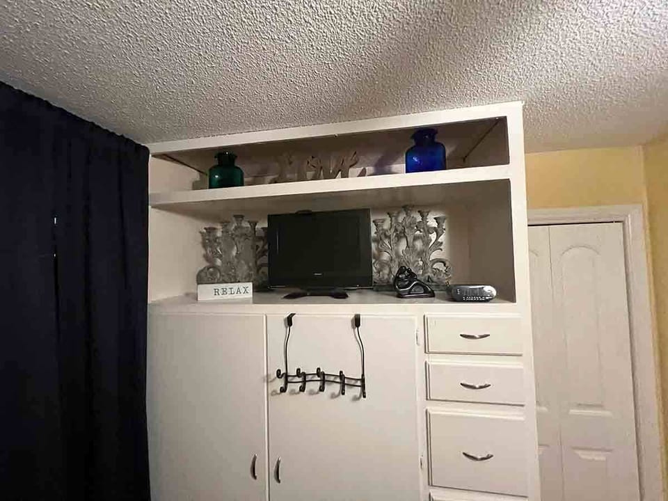 Roku TV with YouTube TV in queen bedroom 2