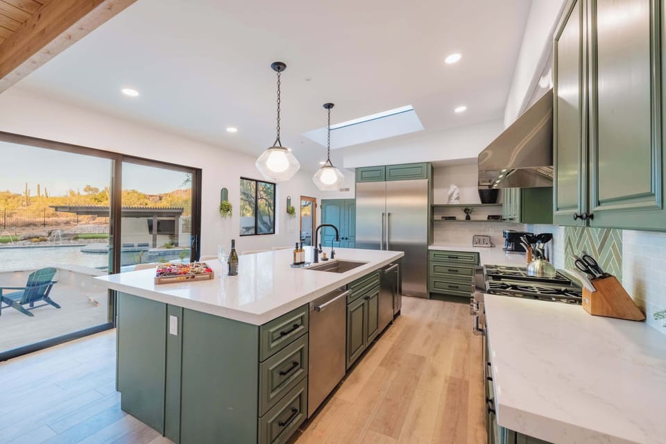 Chef’s Kitchen with Pool Views - A gourmet kitchen designed for entertaining, complete with a massive island, professional-grade appliances, and sleek quartz countertops — all overlooking the stunning pool and backyard oasis.