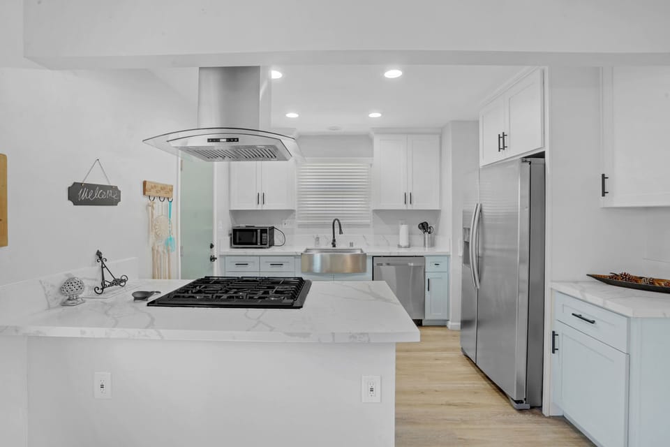 Fully Stocked Kitchen with all new appliances, large farm sink, and granite tops