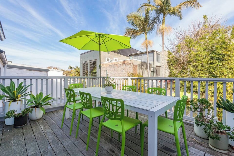 Enjoy alfresco dining on the sunny balcony, complete with a table for eight and vibrant outdoor vibes.

