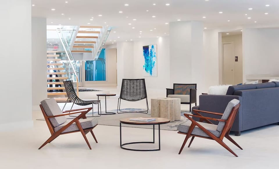 Unwind in sleek lounge seating beneath bright, modern lighting.