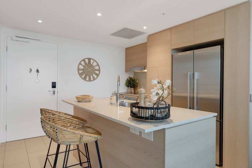 A sleek stone island with rattan stools sets the scene for relaxed breakfasts or evening wine chats.