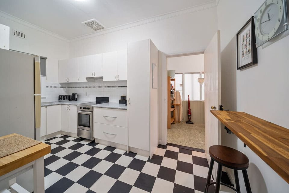 Prepare meals with ease in a bright kitchen that keeps everything within reach.