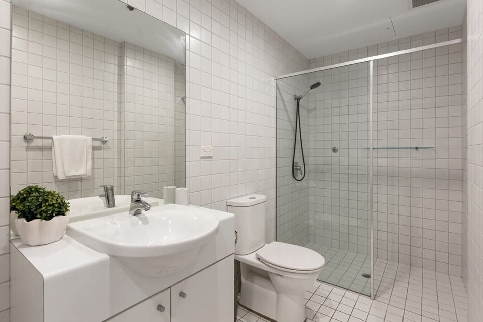 Wash away the day beneath the walk-in shower, with a vanity and toilet completing this practical, well-appointed full bathroom.