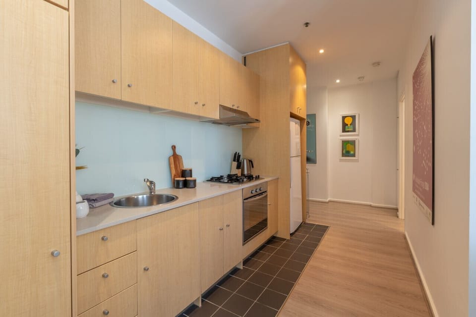 Prepare simple, home-style meals with ease in the well-equipped kitchen of this city retreat.