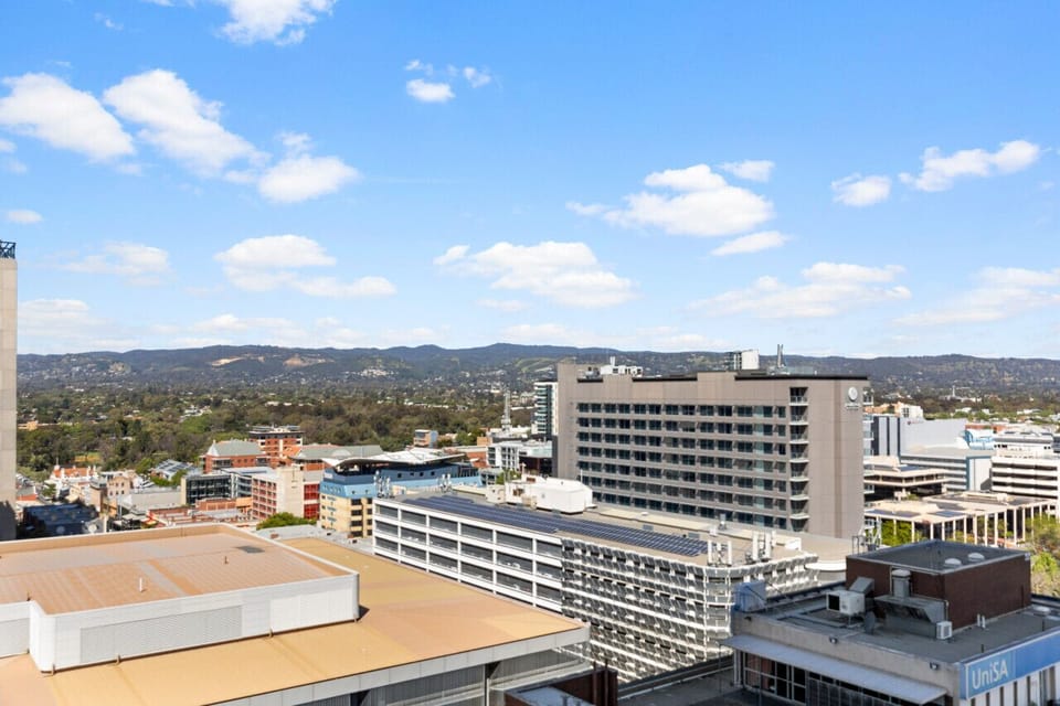 Take in the elevated views from the balcony as the city shifts from day to night.