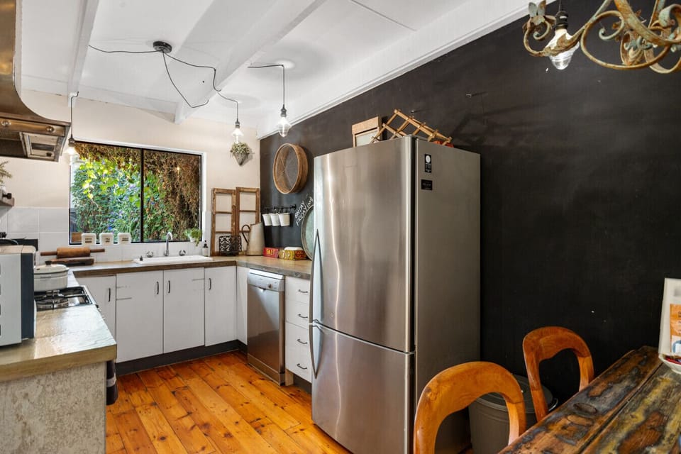 An open plan kitchen and dining area encourages connection over shared meals and at-home cooking.