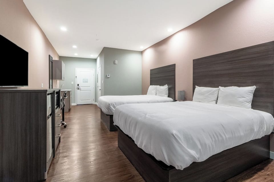 Unwind in crisp linens with a bright, spacious room.