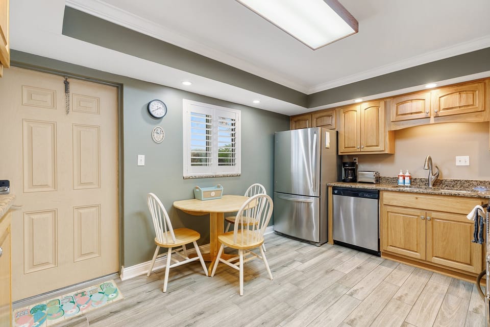 Enjoy a coastal-inspired kitchen with a cozy breakfast nook—perfect for fueling up before a fun beach day. Bright, inviting, and ideal for your seaside stay.