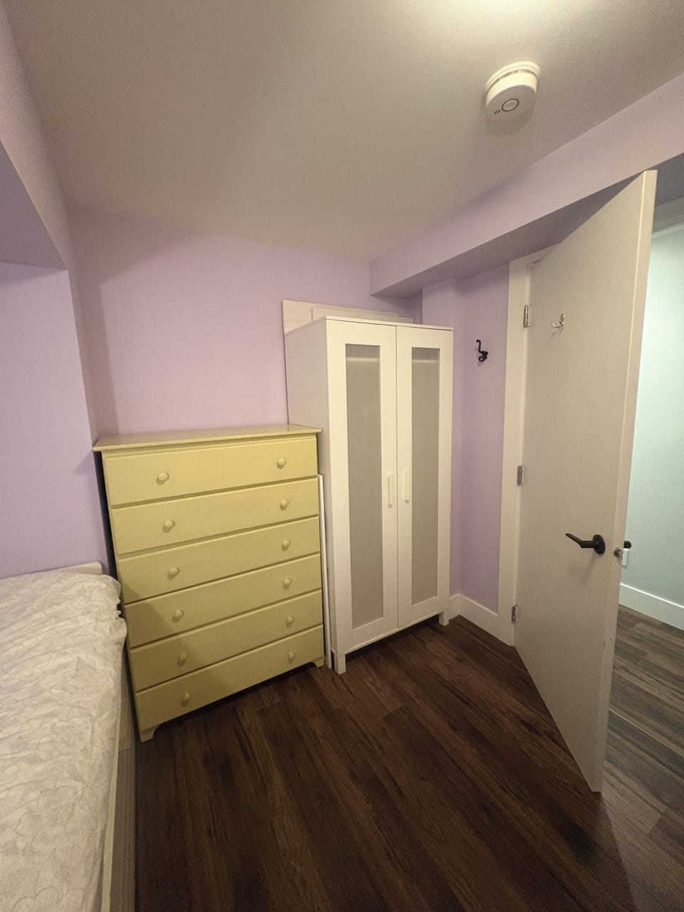 Smaller room includes desk, dresser, and armoire. 