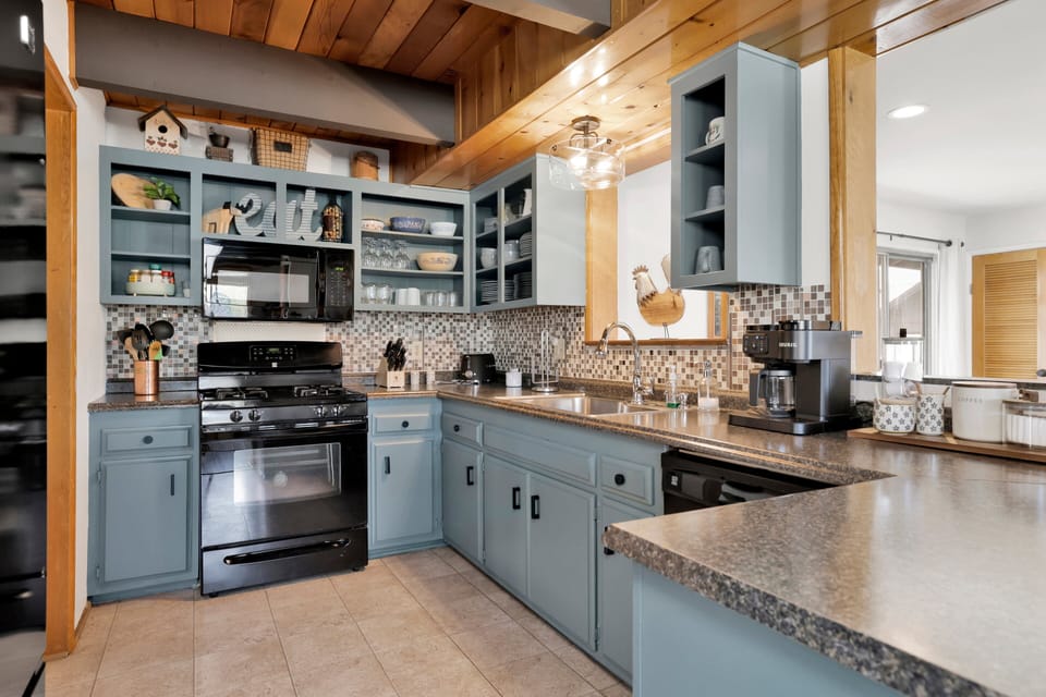Fully equipped cabin kitchen with ample cabinetry, stove, fridge, and coffee maker—perfect for cooking meals, morning coffee, and feeling right at home on your stay.