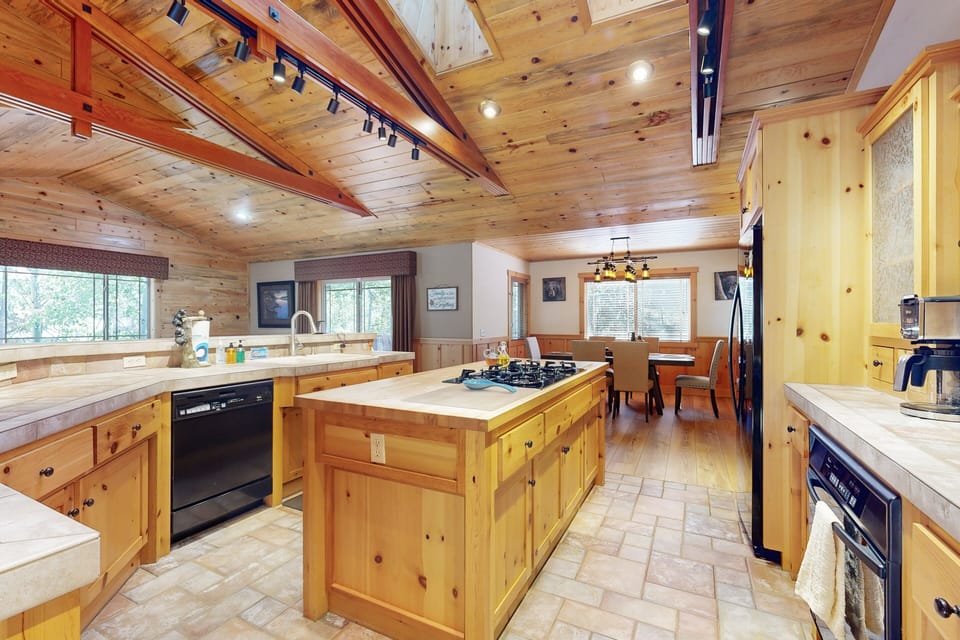 Fully equipped cabin kitchen with ample cabinetry, stove, fridge, microwave, and coffee maker—perfect for cooking meals, morning coffee, and feeling right at home on your stay.