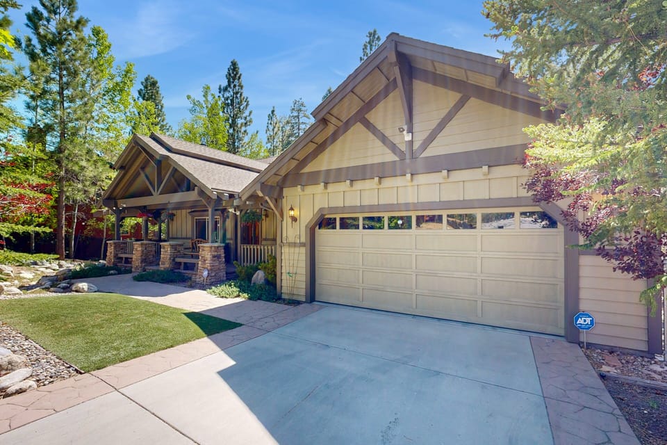 Welcoming cabin entry surrounded by towering pine trees, offering fresh mountain air and a peaceful forest setting—the perfect first impression for your Big Bear Lake getaway.