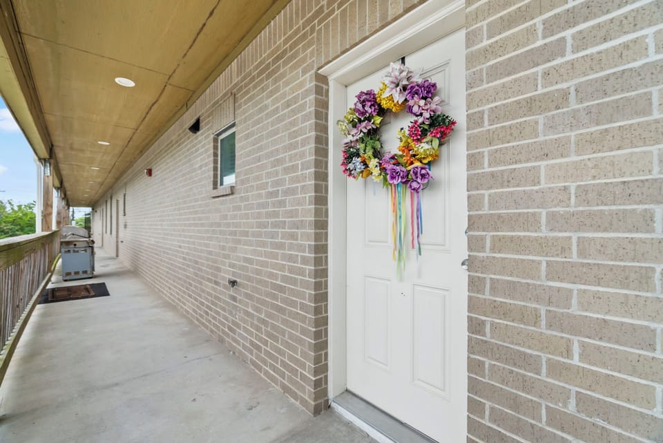 Front door is located above the Exxon gas station; there are stairs on either side of the building.