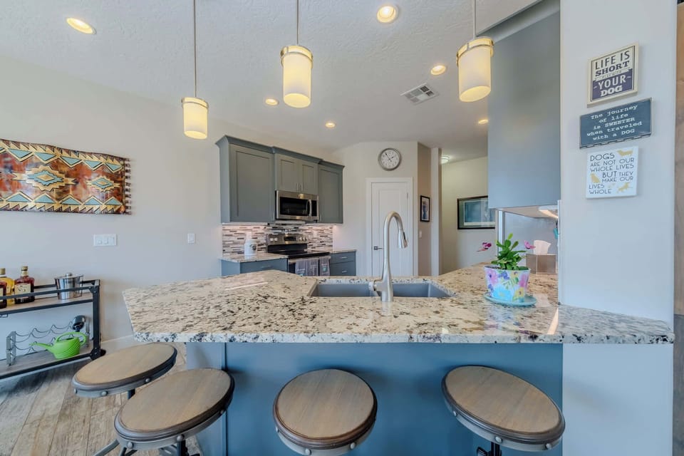 The fully stocked kitchen offers plenty of counter space and additinal seating for 4 at the bar
