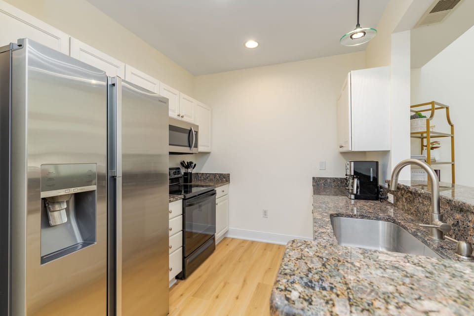 Fully equipped kitchen with full-size appliances, cookware, and utensils.
