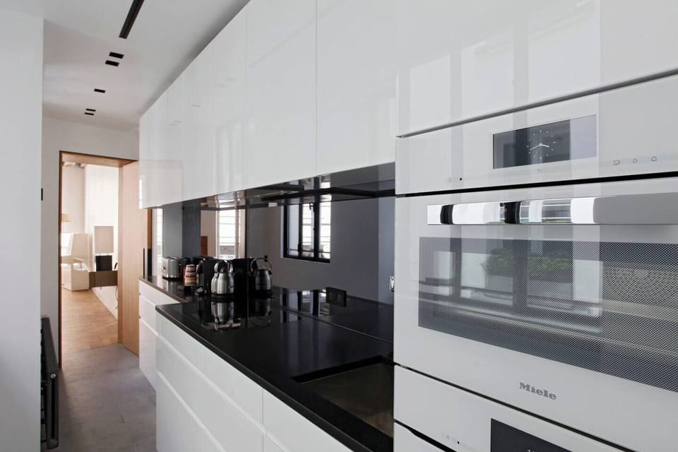 Kitchen - Black granite bench, steam oven above the standard oven
