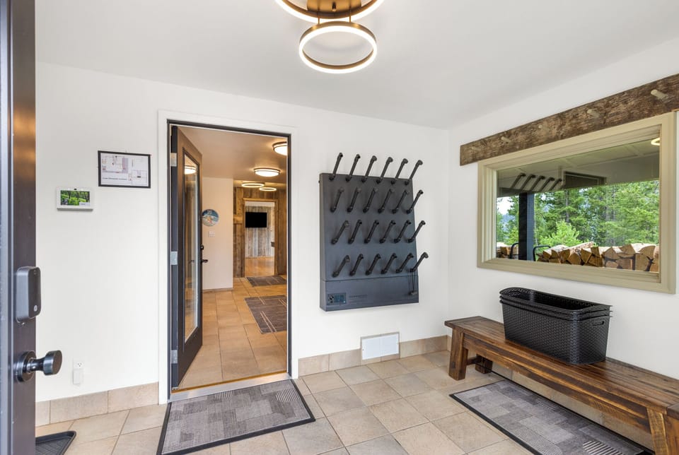 Step into your mountain retreat through this inviting entryway, where rustic wood accents and thoughtful storage await your arrival.