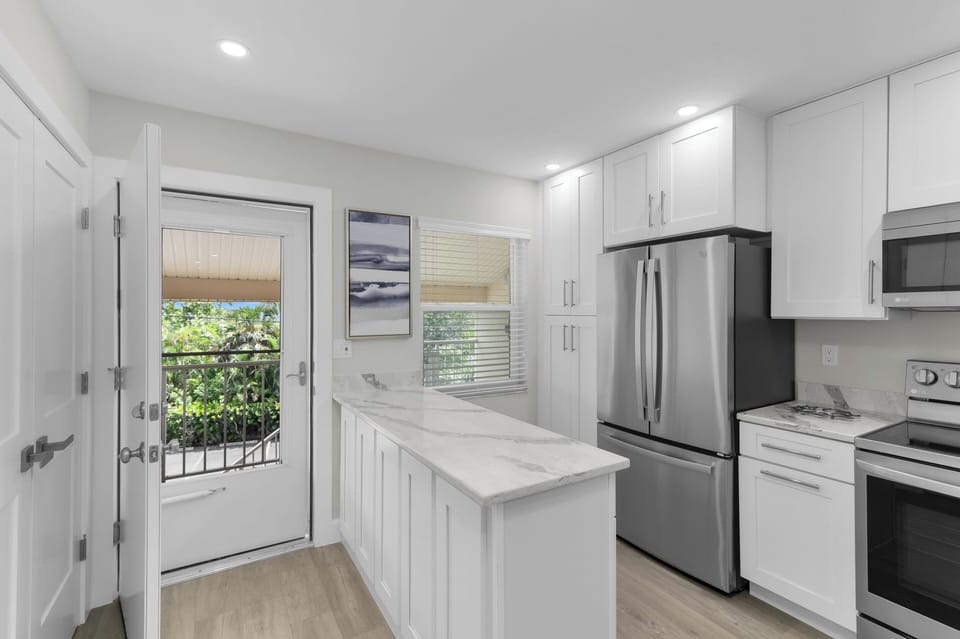 bright airy kitchen with plenty of storage and prep room