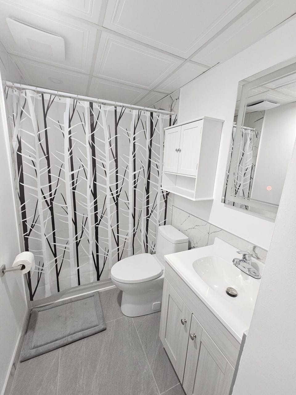 Modern bathroom with vanity, toilet, and shower