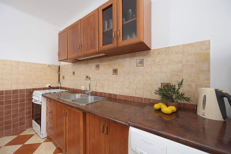 A functional and charming kitchen with ample countertop space, and a cozy table perfect for morning coffee or quick meals.