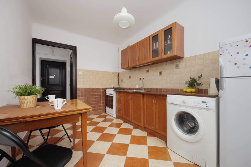A functional and charming kitchen with ample countertop space, and a cozy table perfect for morning coffee or quick meals.