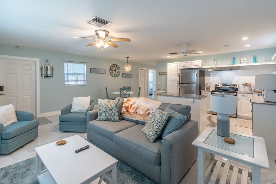 Modern living room with plush seating, elegant décor, and a well-lit space :)