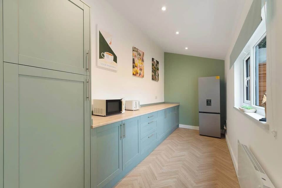 Kitchen equipped with all essentials, including a washer & dryer, oven, fridge and full cookware set.