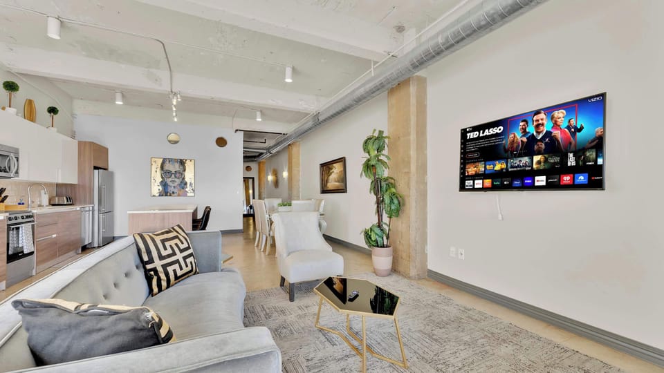 Living Room: Art-infused elegance with modern comforts and city views awaits your getaway!