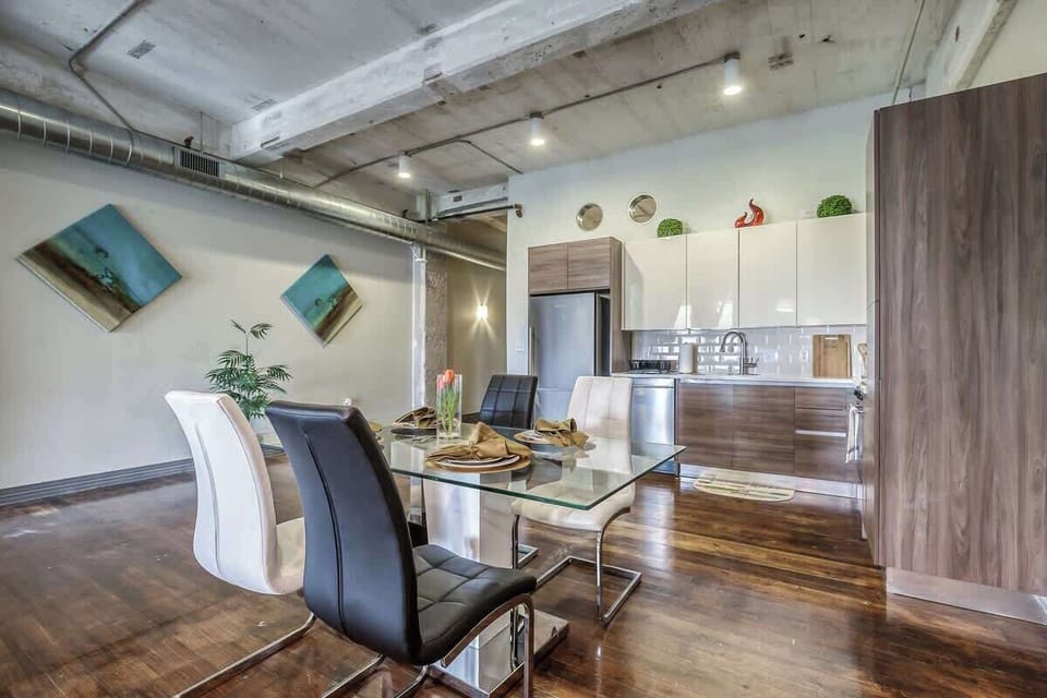 Gather around the stylish table for meals and laughter in this chic space!