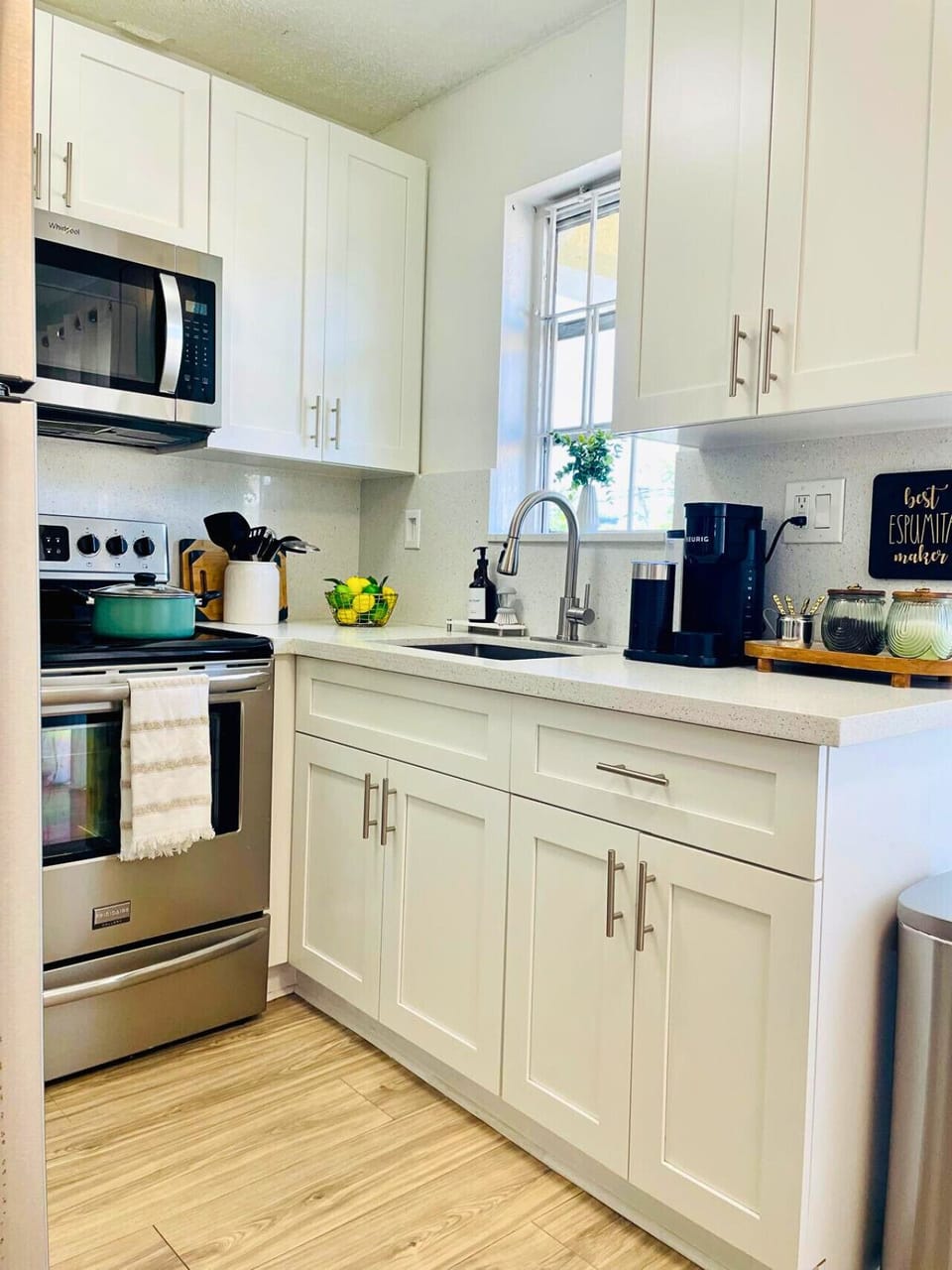 Bright, modern kitchen with quartz countertops, shaker-style cabinets, and all the essentials to make your stay comfortable.