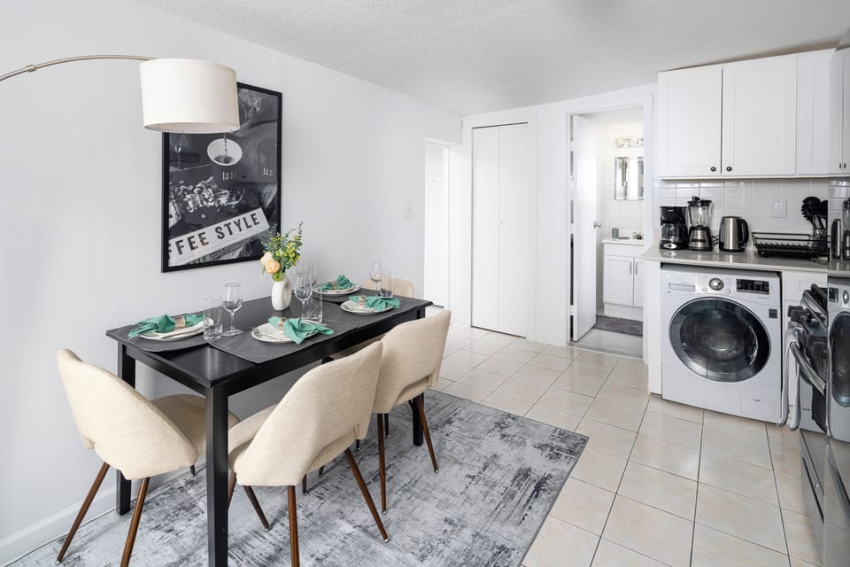 Cozy dining area with full kitchen, washer, and coffee station