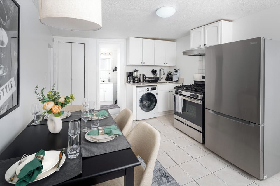 Full kitchen with washer, appliances, and adjacent dining space