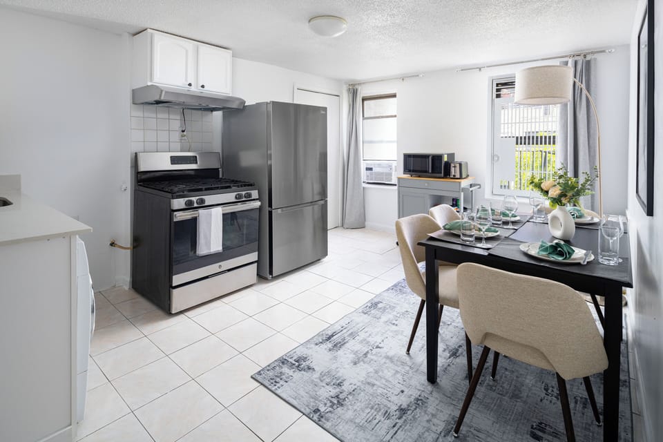 Bright kitchen & dining area with modern appliances and seating for four