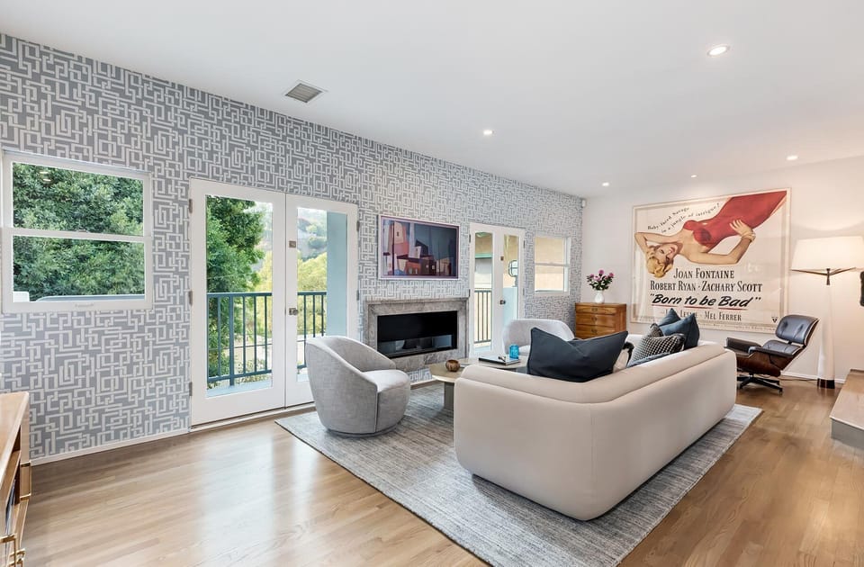 Living Room with dual balconies, fireplace, French doors and mini bar