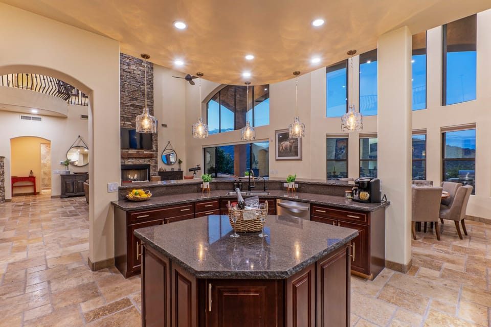 Modern kitchen is spacious and delightful for prepping and serving home cooked meals.