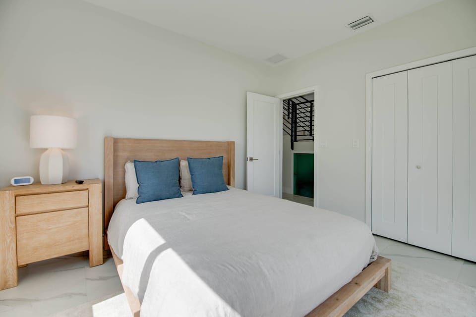 Bedroom 2 on the first floor features a relaxing queen bed and ample storage, providing comfort and convenience for your stay.