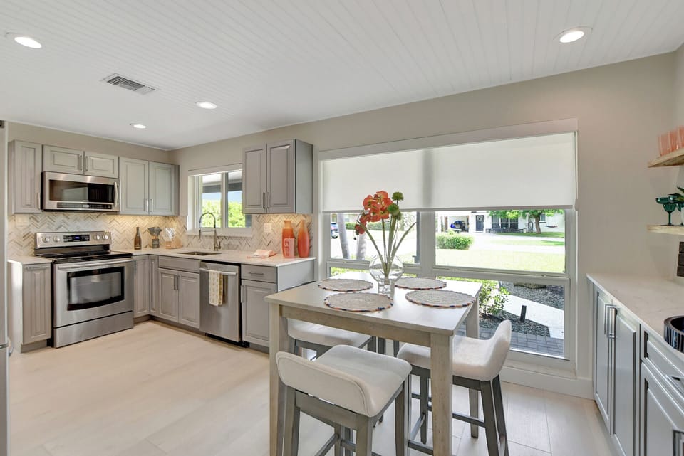 From the bistro area to the well-equipped kitchen, every detail is thoughtfully designed for convenience. With ample natural light streaming in through the expansive windows, cooking becomes a delight in our Delray Beach haven.