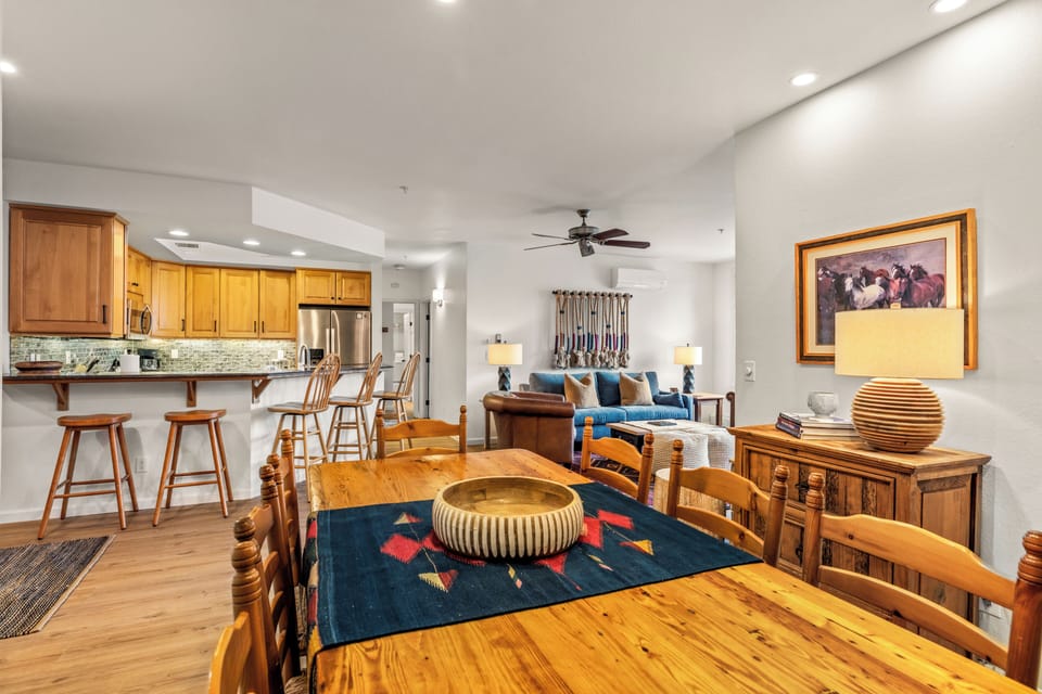 Gather around this beautiful wooden dining table while staying connected to the kitchen and living areas in this open, inviting space.