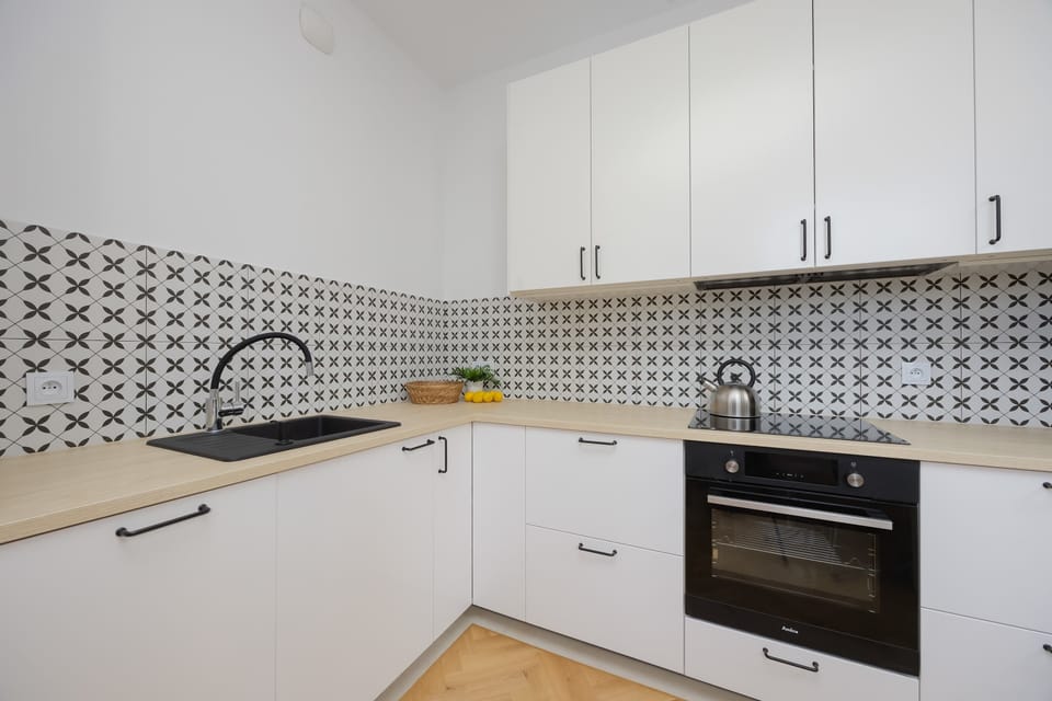 The sleek design of the kitchenette blending seamlessly with the living area.