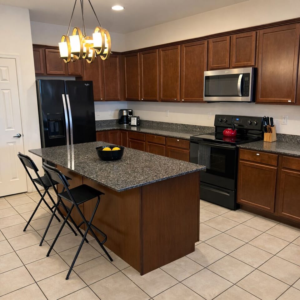 Full kitchen with large island and bar seating for quick bites.