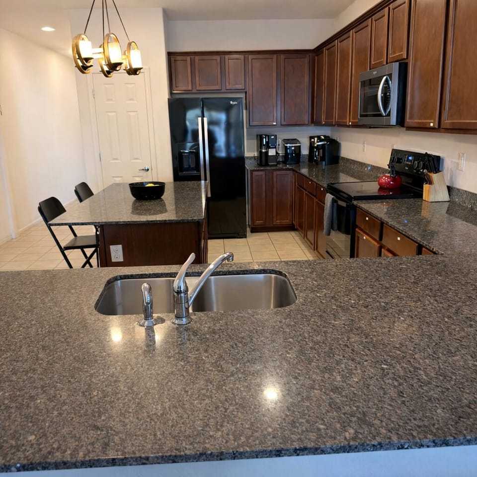 Spacious kitchen counters with double sink and prep space.