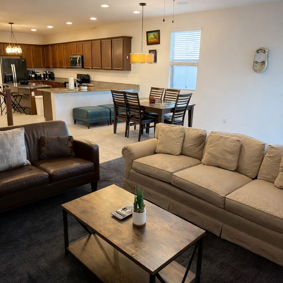 Open living room + kitchen layout with comfy seating and Smart Samsung TV.