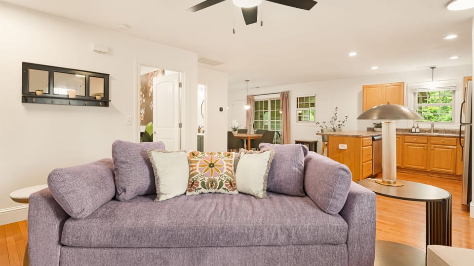 The kind of sofa you don't want to get up from- deep cushions, boho pillows, kitchen 20 feet behind you.