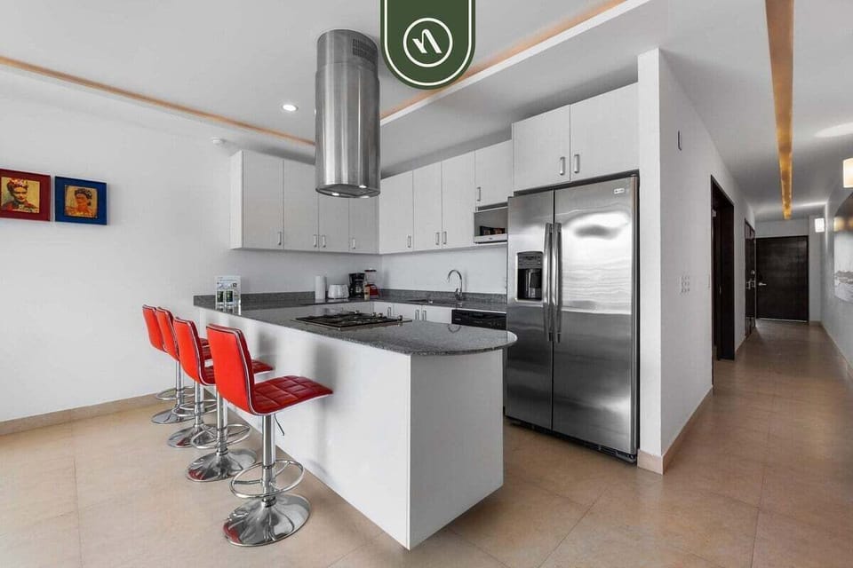 Cook with ease in this spacious, fully equipped kitchen. It boasts stainless steel appliances, ample counter space, and a fun breakfast bar.