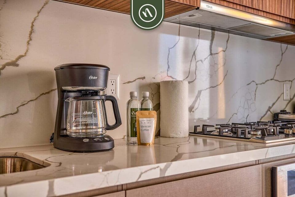 Start your mornings with fresh coffee in the fully equipped kitchen, thoughtfully stocked with essentials for a comfortable and convenient stay.