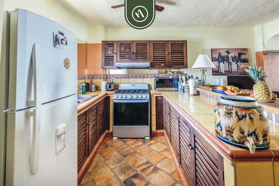 Modern kitchen with stainless steel appliances and ample workspace.
