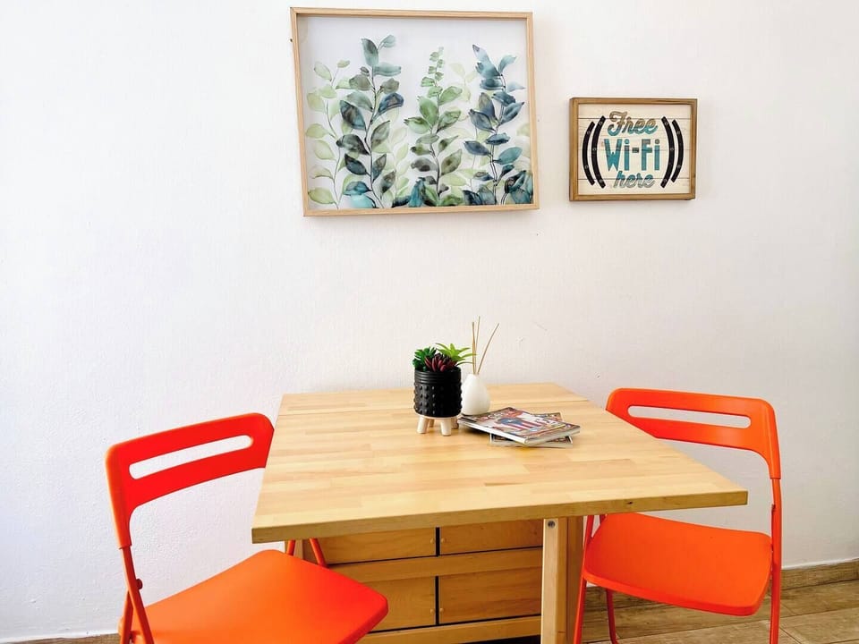 Gather around our welcoming dining table, adorned with captivating wall art – the perfect spot for memorable meals, lively conversations, and planning your next adventure.